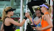 Eugenie Bouchard of Canada shakes hands with Russia's Maria Sharapova after beating her in their WTA Madrid Open tie.