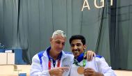 Qatari gymnast Ahmed Al Dayani (right) shows off his bronze medal won at the Islamic Solidarity Games in Baku.