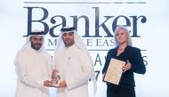 A senior QNB official receiving the recognitions at the 'Banker Magazine' award ceremony.