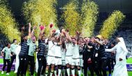 The jubilant Al Sadd players and officials celebrate with 2017 Emir's Cup at Khalifa International Stadium yesterday. Al Sadd registered a fighting 2-1-win over Al Rayyan in an exciting final to bag their 16th Emir Cup title.
