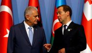 Turkish Prime Minister Binali Yildirim and his Russian counterpart Dmitry Medvedev chat as they pose for a group photo during the 25th anniversary summit of the Organisation of the Black Sea Economic Cooperation (BSEC) in Istanbul, Turkey, May 22, 2017. R