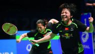 Chen Qingchen (right) and Jia Yifan of China celebrate their victory in the women's doubles Sudirman Cup match against Misaki Matsutomo and Ayaka Takahashi of Japan at the Gold Coast Sports Centre, yesterday.