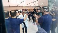 Angela Jean Ahrendts (in white), Senior Vice-President of retail at Apple Inc, greets her employees inside the Apple store in the Orchard shopping district on its opening day in Singapore yesterday. 
