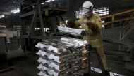 A worker stacks aluminium ingots at the foundry shop of the Rusal Sayanogorsk aluminium smelter outside the town of Sayanogorsk, Russia, September 3, 2015. REUTERS/Ilya Naymushin