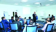 A QIB  official highlighting the features of its wide-ranging Treasury Products and Services to representatives from Qatari SMEs.