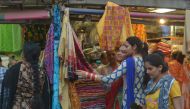 Indian customers browse at a shop selling women's suits and wedding outfits in a market in Amritsar on May 30, 2017. (AFP / NARINDER NANU)