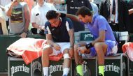 Spain's Nicolas Almagro (L) is comforted by Argentina's Juan Martin Del Potro as he has to give up due to an injury during their tennis match at the Roland Garros 2017 French Open on June 1, 2017 in Paris. (AFP / Thomas SAMSON)