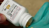 A pharmacist holds prescription painkiller OxyContin, 40mg pills, made by Purdue Pharma L.D. at a local pharmacy, in Provo, Utah, U.S., April 25, 2017. REUTERS/George Frey