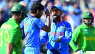 India's Bhuvneshwar Kumar (second left) celebrates the wicket of Pakistan's Ahmed Shehzad with India's captain Virat Kohli during the ICC Champions trophy match at Edgbaston in Birmingham, yesterday.