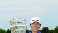 Kim In-Kyung of South Korea holds the championship trophy after winning the ShopRite LPGA Classic presented by Acer on the Bay Course at Stockton Seaview Hotel & Golf Club in Galloway, New Jersey, on Sunday.