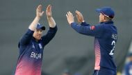 England's Alex Hales and Eoin Morgan (left) celebrate the wicket of New Zealand's James Neesham during their Champions Trophy match at Sophia Gardens on Tuesday.