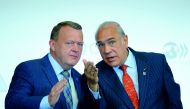Prime Minister of Denmark Lars Rasmussen (left) speaks with OECD General-Secretary Angel Gurria after addressing the opening of a meeting at OECD headquarters in Paris, yesterday.
