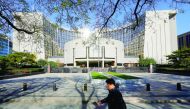 A man walks past the headquarters of the People’s Bank of China (PBOC), the central bank, in Beijing.