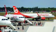 Passengers board a German carrier Air Berlin aircraft at Tegel Airport in Berlin, Germany, yesterday.