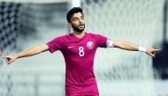 A Qatari player celebrates after scoring a goal.