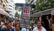 Cloth merchants and workers shout slogans as they carry an effigy depicting Goods and Services Tax (GST) in a market area during a protest rally against implementation of GST on textiles in Kolkata, India, June 28, 2017. (REUTERS/Rupak De Chowdhuri)