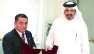 Mohamed bin Ahmed bin Tawar Al Kuwari (right), Vice-Chairman, QC, honouring Venezuelan minister, Douglas Sosa.