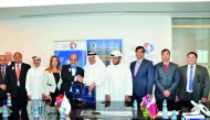 Abdul Rahman A Al Ansari, CEO of QIMC, shaking hands with Dr R Seetharaman, CEO of Doha Bank, after the signing ceremony. 