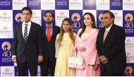 Reliance Industries chairman Mukesh Ambani (R) and his wife Nita Ambani (2R) pose with their children (L-C) Akash Ambani, Anant Ambani and Isha Ambani as they arrive for the company's 40th AGM in Mumbai on July 21, 2017. (AFP / INDRANIL MUKHERJEE)