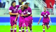 Qatar’s Khalfan Ibrahim (centre) celebrates with team-mates after scoring a goal during a friendly against Australia at the Lekhwiya Stadium in Doha, in this file photo.