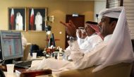 FILE PHOTO: Traders monitor screens displaying stock information at Qatar Stock Exchange in Doha in this photo of November 9, 2016 (REUTERS / Naseem Zeitoon) 