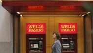 A woman walks past teller machines at a Wells Fargo bank in San Francisco, California in this October 10, 2013 file photo (REUTERS / Robert Galbraith) 