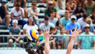 Qatar’s Cherif Younousse (left) attacks while a German player tries to block the ball during their opening match of the World Beach Volleyball Championships in Vienna, Austria on Friday.