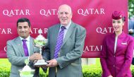 Qatar Racing and Equestrian Club (QREC) Board Member, Khalid bin Mohammed Al Ali presenting the winners’ trophy to John Cook, owner of Breton Rock who won the G2 Qatar Lennox Stakes on the opening day of the Qatar Goodwood Festival in West Sussex, England