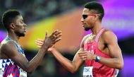 Qatar’s Abderrahaman Samba (right) is congratulated by French athlete Ludvy Vaillant after he won the men’s 400m hurdles heat-three of the 2017 IAAF World Championships at the London Stadium in London yesterday.