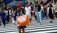 A woman carries a shopping bag at a shopping district in Tokyo, yesterday.