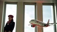 An hostess standing next to a model airplane of German airline Air Berlin. (AFP / ODD ANDERSEN / File photo)