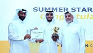 RasGas’ Chief Executive Officer, Hamad Mubarak Al Muhannadi (right) awarding the RasGas Summer Internship Star 2017 winner, Mohammed Al Shereem. 