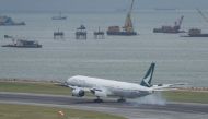A Cathay Pacific passenger plane lands at Hong Kong's international airport on August 16, 2017. The city's flagship airline Cathay Pacific was expected to announce its half-year results later in the day. / AFP / Anthony WALLACE