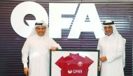 Qatar Football Association (QFA) and President of QSLM, Sheikh Hamad bin Khalifa bin Ahmed Al Thani (right) and QNB Group CEO Ali Ahmed Al Kuwari display the QNB logo on a football jersey during a press conference held yesterday.