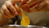 A pastry chef breaks an egg as she prepares to bake a cake at a bakery in Seoul, South Korea, December 22, 2016 (Reuters / Kim Hong-Ji) 