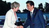 British Prime Minister Theresa May (left) is welcomed by Japanese Prime Minister Shinzo Abe upon her arrival for a Japan-UK dinner at the Kyoto State Guesthouse in Kyoto, yesterday. 