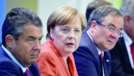 German Chancellor Angela Merkel (centre) with Sigmar Gabriel (left) German Vice Chancellor and Foreign Minister;  and Armin Laschet (right), North Rhine-Westphalia’s state premier as they address the media after a meeting on improving electric car infrast