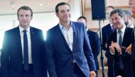 French President Emmanuel Macron (left) and Greek Prime Minister Alexis Tsipras (second left) arrive for a roundtable discussion with French and Greek business leaders yesterday in Athens, as part of a two-day official visit of the French president to Gre
