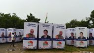 An Indian worker walks past poster witht the picture of Japanese Prime Minister Shinzo Abe and his Indian counterpart Narendra Modi, in Ahmedabad on September 10, 2017.  / AFP / SAM PANTHAKY