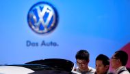Guests look at a Volkswagen car during the media day at 15th Shanghai International Automobile Industry Exhibition in Shanghai April 20, 2013. REUTERS/Aly Song/File Photo
