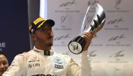 Mercedes' British driver Lewis Hamilton celebrates on the podium after winning the Formula One Singapore Grand Prix in Singapore on September 17, 2017. / AFP / MANAN VATSYAYANA
