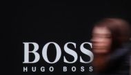 A woman walks past Hugo Boss store logo on a shopping center, April 23, 2016 (Reuters / Grigory Dukor) 