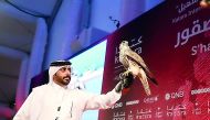 A participant with his falcon at the exhibition.