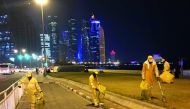 Workers cleaning the Corniche.
