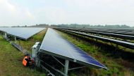Anesco engineer Tommy Good works on Clayhill Solar Power Farm, Britain’s first to operate without a government subsidy in Westoning, Britain, yesterday. Anesco is UK’s leading energy efficiency solution company.