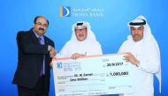 Doha Bank officials present a symbolic cheque for the Dana Millionaire winner. 