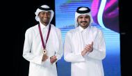 QOC Chairman H E Sheikh Joaan bin Hamad Al Thani (right) and Male Athlete of the Season and world champion Mutaz Essa Barshim pose for a photograph yesterday.