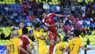 Omar Al Somah of Syria (centre) heads the ball during the 2018 World Cup qualifier against Australia at the Hang Jebat Stadium in Malacca  yesterday. Al Soma scored through a late penalty as Syria drew 1-1 with Australia to put their two-legged World Cup 