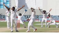 Sri Lanka cricket players celebrate the dismissal of Muhammad Amir (2L) of Pakistan during the Test cricket match between Pakistan and Sri Lanka at Dubai International Cricket Ground in Dubai on October 10, 2017. (AFP / KARIM SAHIB)
