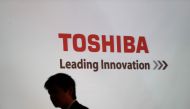 A man walking past the logo of Toshiba Corp displayed at the company headquarters in Tokyo on February 14, 2017 (AFP / Behrouz Mehri) 